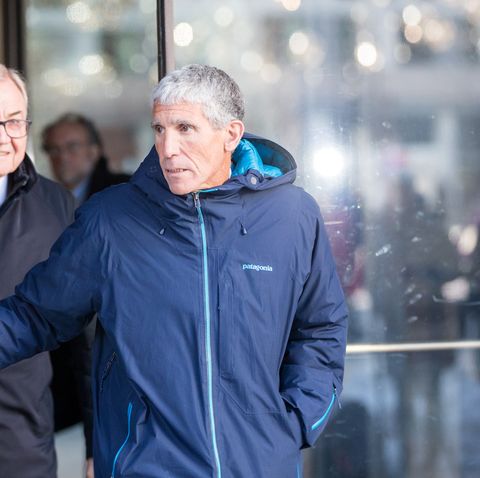 rick singer exiting a courthouse wearing a blue patagonia jacket